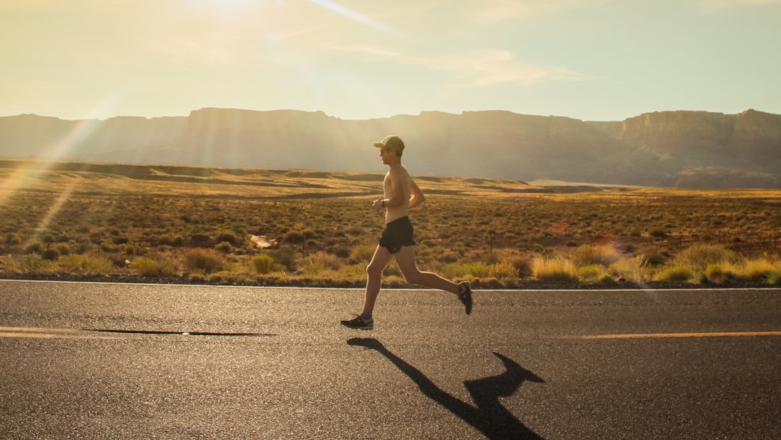 Runner on an open road in morning light