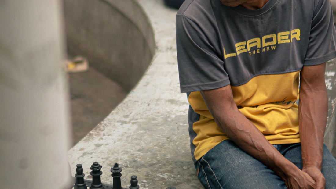 Man playing chess alone outdoors, considering his next move